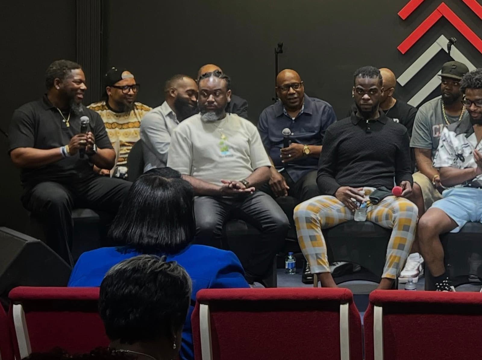 Men of Advance Church seated together on stage for a HUB panel discussion