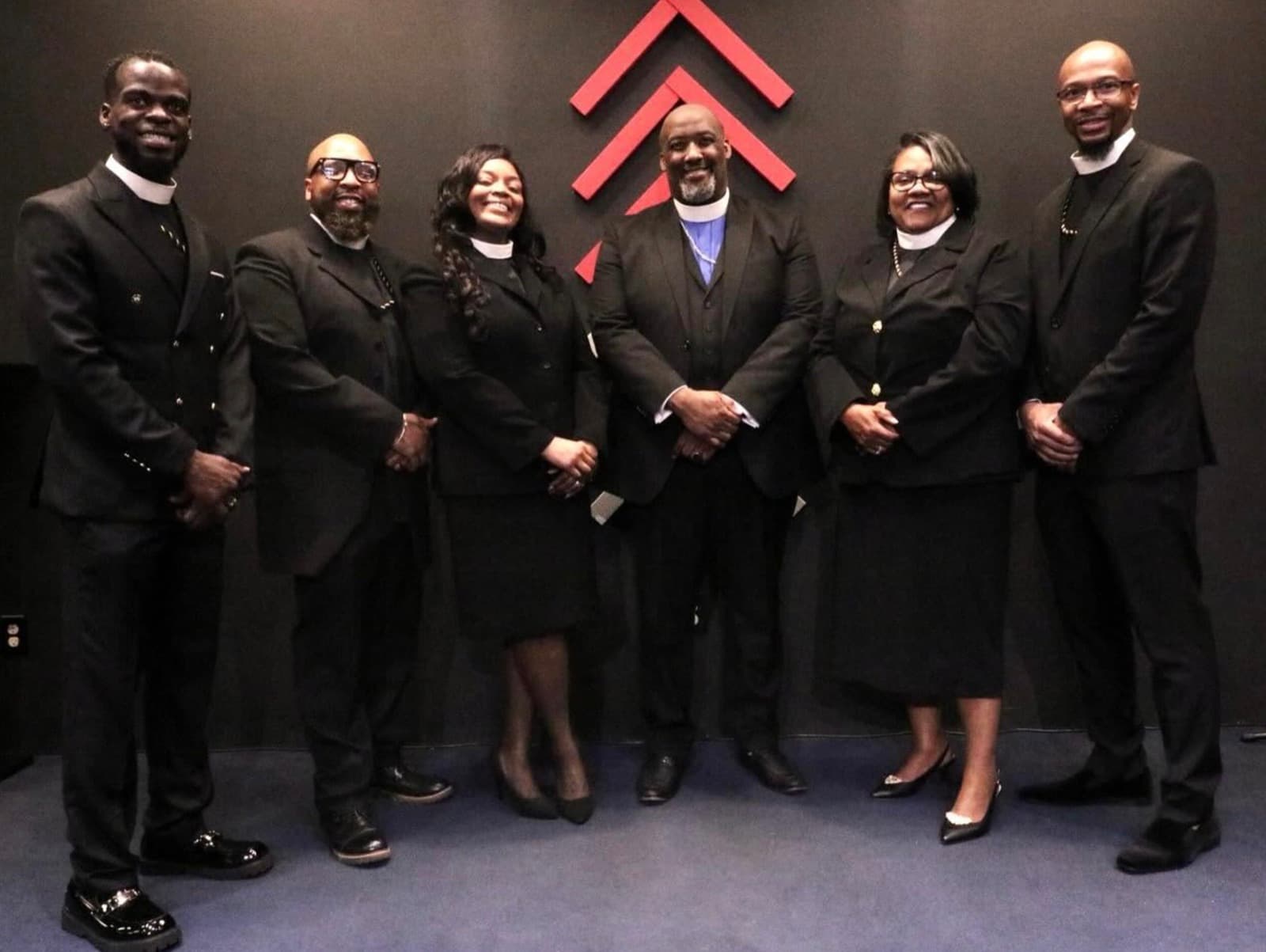 The leadership team of Advance Church standing together in the sanctuary