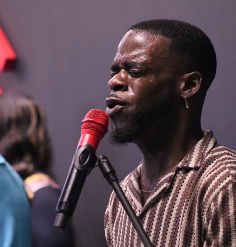 A worship singer at the microphone during a service at Advance Church